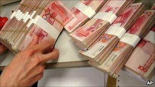 A person handling Chinese yuan bills