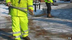 council workers putting grit on roads