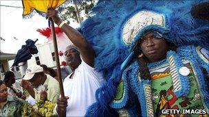 A Mardi Gras Indian in a traditional second line parade in New Orleans