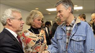 Jon Huntsman, right, shakes hands with a voter in New Hampshire