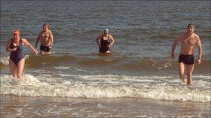 Swimmers walking out of the North Sea