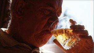 Elderly man drinking