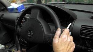 Man smoking in car