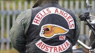 A member of the Hells Angels waits outside during the funeral for Melbourne crime figure Macchour Chaouk at Preston Mosque on August 16, 2010 in Melbourne, Australia