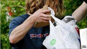 Man emptying rubbish into bin