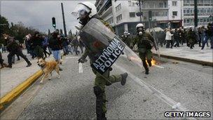 A Greek riot police officer running
