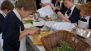 Children peeling vegetables