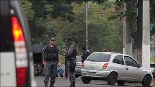 Paramilitary police block a street outside the Engenho complex shantytown in Rio de Janeiro, Brazil, on June 23, 2011