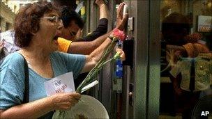 A women demands to be let into a bank