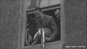 Tommy Lawton standing in the window with the ball