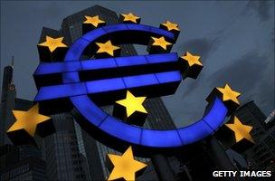 A Euro logo stands in front of the headquarters of the European Central Bank