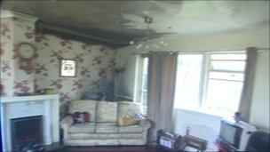 Smoke damage in a living room that had a sprinkler installed