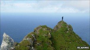 Survey team member on Mullach an Eilein, the highest point on Boreray. Image: RCAHMS