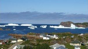 Icebergs surrounding a village