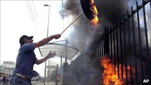 Demonstrator throws a burning tyre in Buenos Aires, 17 December 2001