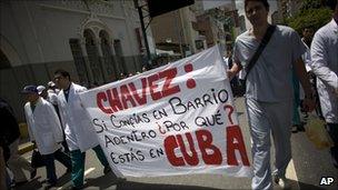 Public doctors and nurses protest to demand higher wages and better hospital maintenance, in Caracas, Venezuela on 16 June - their banner asks why Mr Chavez is in Cuba if he backs a programme to bring Cuban doctors to Venezuela