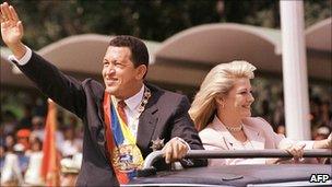 Hugo Chavez and wife Marisabel Rodriguez de Chavez in open-top motorcade