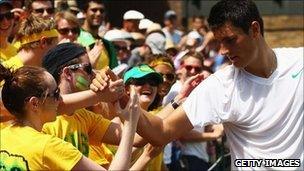 Bernard Tomic shakes hands with fans after winning his fourth round match against Xavier Malisse on June 27, 2011