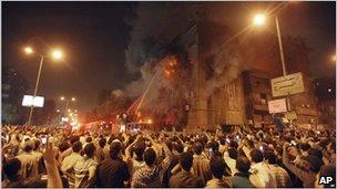 Firemen spray water into flames coming from Saint Mary Church, Cairo