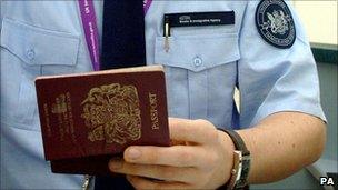 A passport being checked by a UK Border Agency staff member.