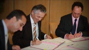 Jersey Electricity CEO Chris Ambler signs the contract with EDF’s Group Vice President, Pierre Lederer and Guernsey Electricity's MD Chris Bates at EDF's Paris headquarters