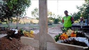 Laisa do Espirito Santo visits the graves of her sister Maria do Espirito Santo da Silva and brother-in-law Jose Claudio Ribeiro da Silva, murdered in Para