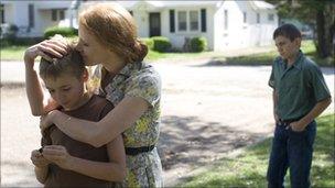 Laramie Eppler, Jessica Chastain, and Hunter McCracken are shown in a scene from "The Tree of Life."