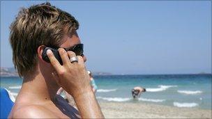 Man talking on phone on beach