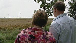 Jane and Julian Davis with wind farm in the distance