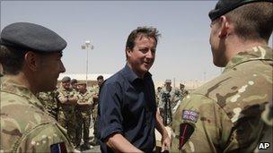 Prime Minister David Cameron talks with British troops during a visit at Camp Bastion on 4 July