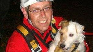 Trixie the Jack Russell dog with a member of the Gloucestershire Fire and Rescue service