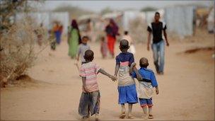 Children walk down a dusty street in Dadaab refugee camp in Kenya on July 4, 2011.