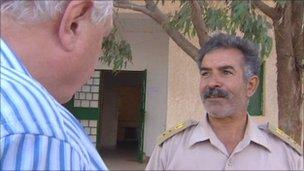 Col Moftah Ali Abdullah speaks to the BBC's John Simpson (L)
