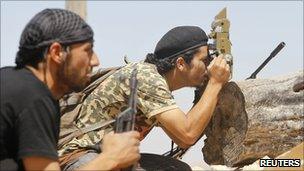 Near Kikla, a rebel fighter uses an optical sight from a captured government
