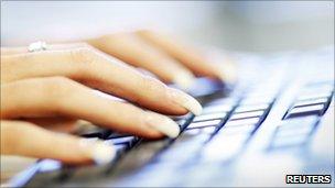 A woman uses a computer keyboard (file photo)