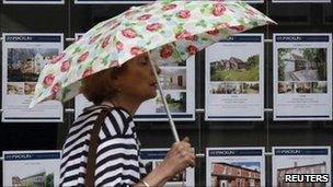 lady walks past estate agent