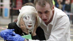 Paul Dadge helps Davinia Turrell (married name now Davinia Douglass) who is wearing a protective gauze mask, following an explosion at Edgware Road Tube Station on 7/7.