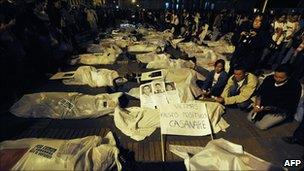 Colombians demonstrate by covering themselves with sheets pretending they are false positive victims, Bogota (MAURICIO DUENAS/AFP/Getty Images, 6 March 2009)