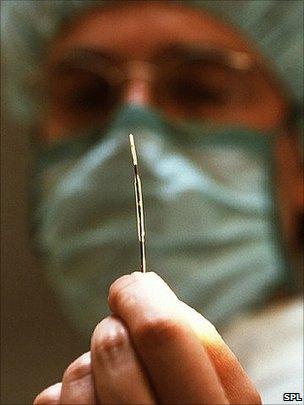 Doctor holding up a stent