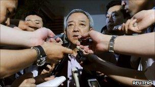 Ryu Matsumoto is surrounded by reporters at the prime minister"s official residence in Tokyo, Japan, Monday, June 27, 2011