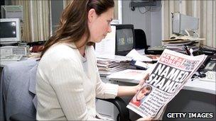 Office worker reading paper