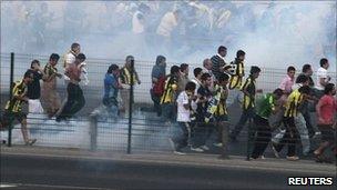 Fenerbahce supporters in clouds of tear gas on the main road to Bosphorus Bridge linking Asia to Europe during a protest in Istanbul, Turkey on 10 July