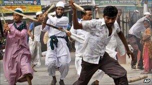 Islamist activists armed with sticks chase anti-strike supporters during a 30-hour nationwide strike in Bangladesh on 10 July 2011