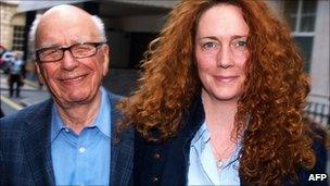 Rebekah Brooks and Rupert Murdoch leave from his London residence