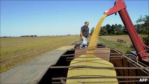 A hopper wagon unloads soybean into a truck in a field in the locality of Perez Millan, 200km from Buenos Aires, in April, 2008.