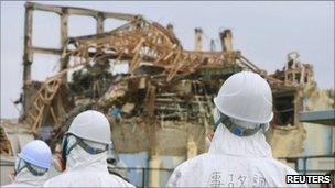 Officials inspect the damaged building housing the No.3 reactor at Fukushima Daiichi nuclear power plant on June 17, 2011