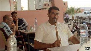 Tunisians smoke sheesha in a cafe in Sidi Bouzid, June 2011