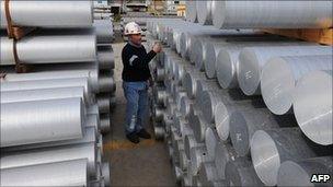 A workers checks stocks of aluminium at Alcoa's plant in Portovesme on the Italian island of Sardinia