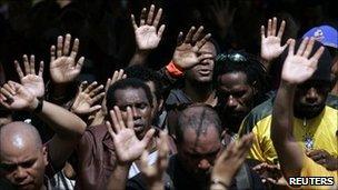 Workers from Freeport-McMoran Copper Gold Inc gather to pray during a week long strike in Kuala Kencana, Timika, in Indonesia's Papua province 11 July 2011