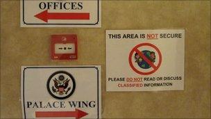 Signs warning against classified conversations in non-secure areas